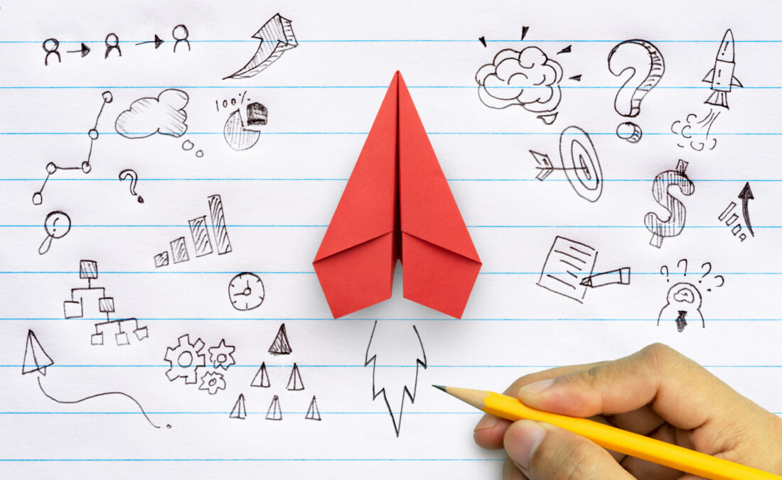 Business success, innovation and solution concept, Red paper plane and business strategy with hand drawing on notebook